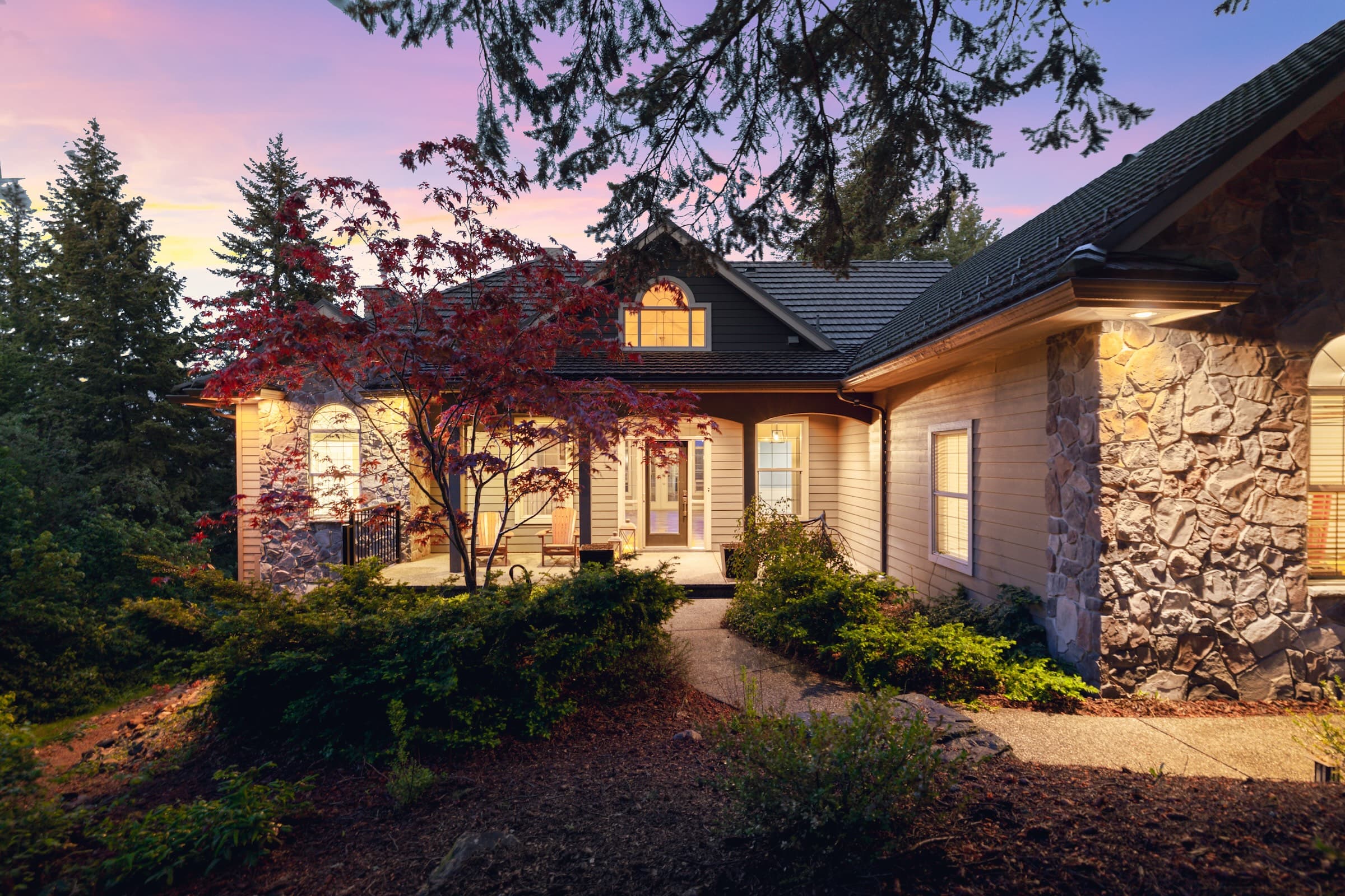 Coachwood Crescent home at twilight with warm lights and stone exterior