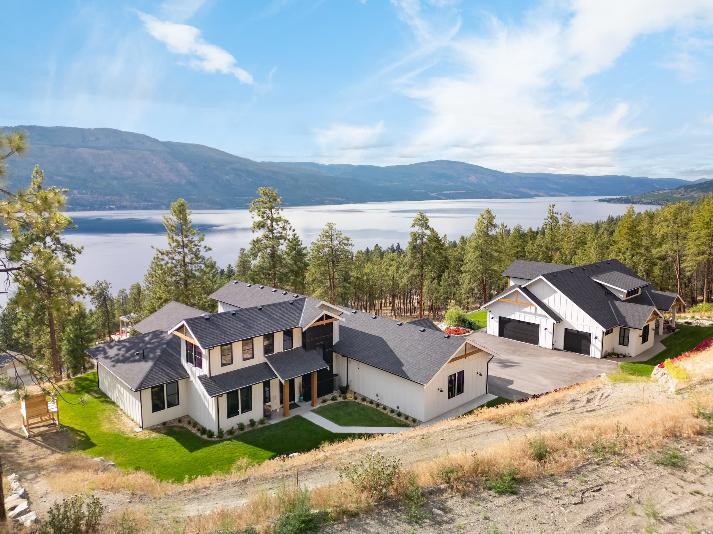 Aerial view of Hare Road luxury estate with Okanagan Lake in background